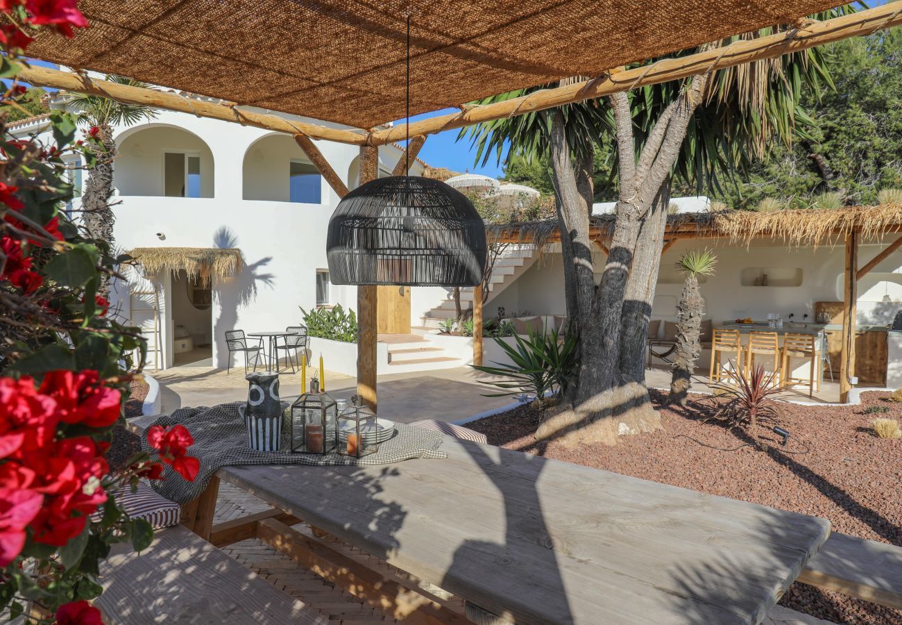 Picnic table in garden with beautiful flowers Picnic table in green garden with beautiful flowers
