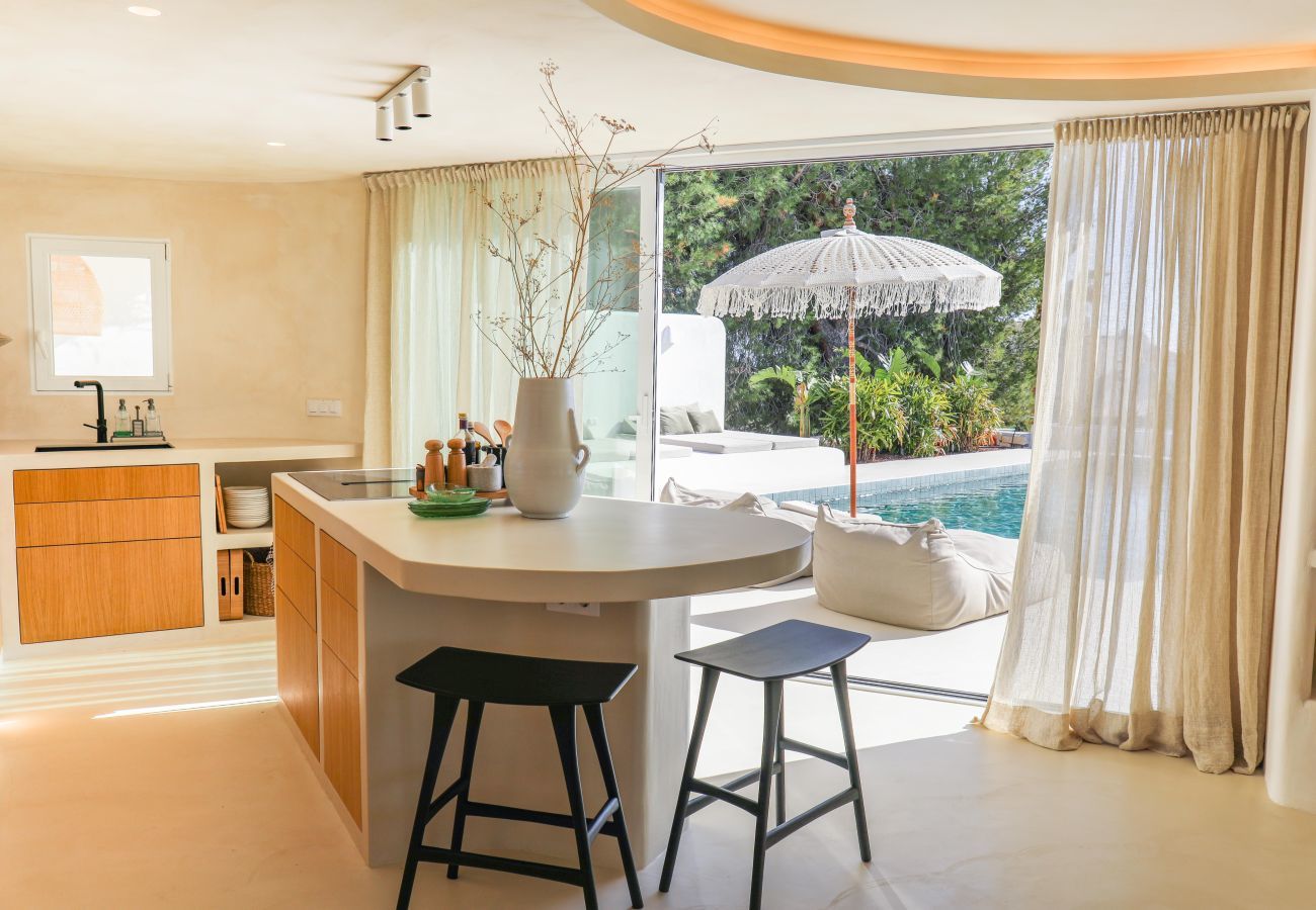 Kitchen with doors opening to the outside Kitchen with patio doors to the terrace by the private pool outside